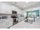 Kitchen with stainless appliances, white cabinets, and quartz countertop open to the dining area at 172 Board Landing Circle, Conway, SC 29526