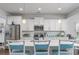 Bright and airy kitchen features white cabinets, stainless steel appliances, and a quartz countertop island at 172 Board Landing Circle, Conway, SC 29526