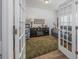 Cozy living room with hardwood floors, fireplace, and comfortable seating visible through French doors at 172 Board Landing Circle, Conway, SC 29526