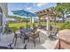 Outdoor patio featuring a pergola, dining table with umbrella, and lounge seating overlooking the fenced backyard at 172 Board Landing Circle, Conway, SC 29526