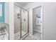 Modern tiled shower featuring glass door and built-in shampoo niche in bathroom at 172 Board Landing Circle, Conway, SC 29526