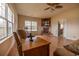 Cozy living room with a fireplace, hardwood floors, and natural light from the large windows at 1771 Southern Crest Dr., Loris, SC 29569