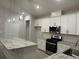 Contemporary kitchen featuring white cabinets, stainless steel appliances, granite countertops, and an island with pendant lighting at 183 Glengrove Lane, Murrells Inlet, SC 29576