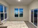 Well-lit kitchen with granite countertops, stainless steel appliances, and a sliding glass door that offers natural light at 183 Glengrove Lane, Murrells Inlet, SC 29576