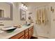 Bathroom featuring dual glass bowl sinks, wooden cabinets, and decorative mirrors at 1878 Heritage Loop, Myrtle Beach, SC 29577