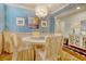 Elegant dining room with a chandelier, round table, and seating for four with coastal decor and blue accent wall at 1878 Heritage Loop, Myrtle Beach, SC 29577