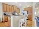 Kitchen with wood cabinets, bar stool seating at the counter, stainless steel appliances with view to the dining room at 1878 Heritage Loop, Myrtle Beach, SC 29577