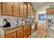 Galley kitchen with stainless steel appliances, wood cabinets and granite countertops that leads into the dining room at 1878 Heritage Loop, Myrtle Beach, SC 29577