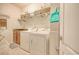 Well-organized laundry room with a washer, dryer, shelving, and storage baskets for convenience at 1878 Heritage Loop, Myrtle Beach, SC 29577