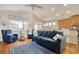 Living room featuring a blue sofa, accent chairs, hardwood flooring and opens up to the kitchen at 1878 Heritage Loop, Myrtle Beach, SC 29577