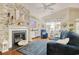 Cozy living room features a brick fireplace, a comfortable blue sofa, and charming coastal-themed decor at 1878 Heritage Loop, Myrtle Beach, SC 29577