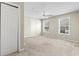 Well-lit bedroom featuring carpeted floors, a ceiling fan, and two windows at 200 Vendura Ct. # B, Murrells Inlet, SC 29576