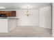 Open-concept dining area with plush carpeting and chandelier lighting at 200 Vendura Ct. # B, Murrells Inlet, SC 29576