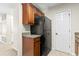 Kitchen featuring dark cabinetry, black appliances and tile flooring at 200 Vendura Ct. # B, Murrells Inlet, SC 29576