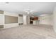 Open-concept living room with neutral carpet, ceiling fan, and adjacent kitchen, great for modern living at 200 Vendura Ct. # B, Murrells Inlet, SC 29576