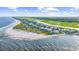 Sweeping aerial of beachfront homes, white sand, and oceanfront living at 202 Spreading Oak Dr., Pawleys Island, SC 29585