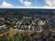 Overhead view of the property in a wooded neighborhood, showcasing a pool and nearby waterfront at 202 Spreading Oak Dr., Pawleys Island, SC 29585