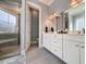 Bathroom with double vanity, walk-in shower, and sleek gray tile flooring at 202 Spreading Oak Dr., Pawleys Island, SC 29585