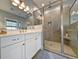 Bright bathroom featuring a glass shower with a built-in seat and a white double vanity with modern fixtures at 202 Spreading Oak Dr., Pawleys Island, SC 29585