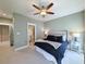A well-lit bedroom featuring a ceiling fan, a comfortable bed with stylish bedding, and coordinated nightstands at 202 Spreading Oak Dr., Pawleys Island, SC 29585