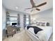 Well-lit bedroom with workstation, ceiling fan, and blue and white accents at 202 Spreading Oak Dr., Pawleys Island, SC 29585