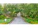 Scenic drive into a gated community, featuring lush trees and landscaping and an access control point at 202 Spreading Oak Dr., Pawleys Island, SC 29585
