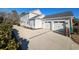 Two-story home with a three-car garage and spacious driveway lined with shrubs, providing ample parking at 202 Spreading Oak Dr., Pawleys Island, SC 29585