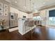 Modern kitchen featuring stainless steel appliances, quartz countertops, pendant lights, and an island with seating at 202 Spreading Oak Dr., Pawleys Island, SC 29585