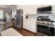 Modern kitchen boasting stainless steel appliances, white cabinetry, and seamless access to the living area at 202 Spreading Oak Dr., Pawleys Island, SC 29585
