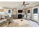 Cozy living room showcasing neutral decor, fireplace with stone accents, and lots of natural light at 202 Spreading Oak Dr., Pawleys Island, SC 29585