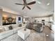 Open-concept living room with hardwood floors, a light color palette, and seamless flow to the kitchen at 202 Spreading Oak Dr., Pawleys Island, SC 29585