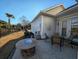 Back patio with built-in fire pit, dining table, and lush green lawn at 202 Spreading Oak Dr., Pawleys Island, SC 29585