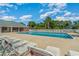 Large community pool surrounded by lounge chairs, palm trees, and lush landscaping at 2033 Silvercrest Dr. # 21 B, Myrtle Beach, SC 29579