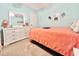 This bedroom features a cozy bed with a coral blanket, dresser, and beach-themed decor at 210 Double Eagle Dr. # G1, Myrtle Beach, SC 29575