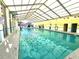 Large indoor pool area featuring abundant natural light and ample seating at 210 Double Eagle Dr. # G1, Myrtle Beach, SC 29575