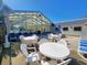 Indoor pool area featuring lounge chairs, tables, and bright windows at 210 Double Eagle Dr. # G1, Myrtle Beach, SC 29575