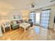 Cozy living room with a plush sofa, wood floors, and a sliding glass door at 210 Double Eagle Dr. # G1, Myrtle Beach, SC 29575