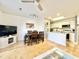 Cozy living room with dining area and adjacent kitchen featuring white cabinets and wood flooring at 210 Double Eagle Dr. # G1, Myrtle Beach, SC 29575