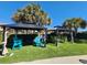 Outdoor lounge area with shaded gazebos, colorful chairs, and manicured turf at 210 Double Eagle Dr. # G1, Myrtle Beach, SC 29575