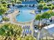 Aerial view of a large outdoor pool with ample seating and lush tropical landscaping at 210 Double Eagle Dr. # G1, Myrtle Beach, SC 29575