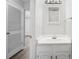Bright bathroom featuring a white vanity with storage and a modern mirror and lighting fixture at 2970 Old Bryan Dr. # A5, Myrtle Beach, SC 29577