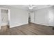 Spacious bedroom with wood-look floors, a ceiling fan, and ample natural light from the hallway bathroom at 2970 Old Bryan Dr. # A5, Myrtle Beach, SC 29577