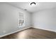 An empty bedroom has light gray walls, wood floors, and a bright window at 2970 Old Bryan Dr. # A5, Myrtle Beach, SC 29577