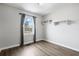 A bright bedroom features wood floors, a window, and built-in shelving at 2970 Old Bryan Dr. # A5, Myrtle Beach, SC 29577