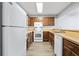 Galley kitchen with bright white appliances, butcher block counters, and wood cabinets at 2970 Old Bryan Dr. # A5, Myrtle Beach, SC 29577
