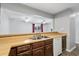 The kitchen has an open view into a common space with wood cabinets and countertops at 2970 Old Bryan Dr. # A5, Myrtle Beach, SC 29577