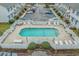 Aerial view of the community pool surrounded by a fence, lounge chairs, and trees at 2970 Old Bryan Dr. # A5, Myrtle Beach, SC 29577