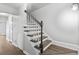 A light-filled staircase with wood stairs and a dark banister leads upstairs at 2970 Old Bryan Dr. # A5, Myrtle Beach, SC 29577