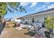 Landscaped backyard with a brick patio and white outdoor seating, perfect for relaxing at 309 Lake Mist Ct. # 309, Longs, SC 29568