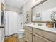 Neutral bathroom featuring a shower-tub, vanity, and decorative mirror at 309 Lake Mist Ct. # 309, Longs, SC 29568